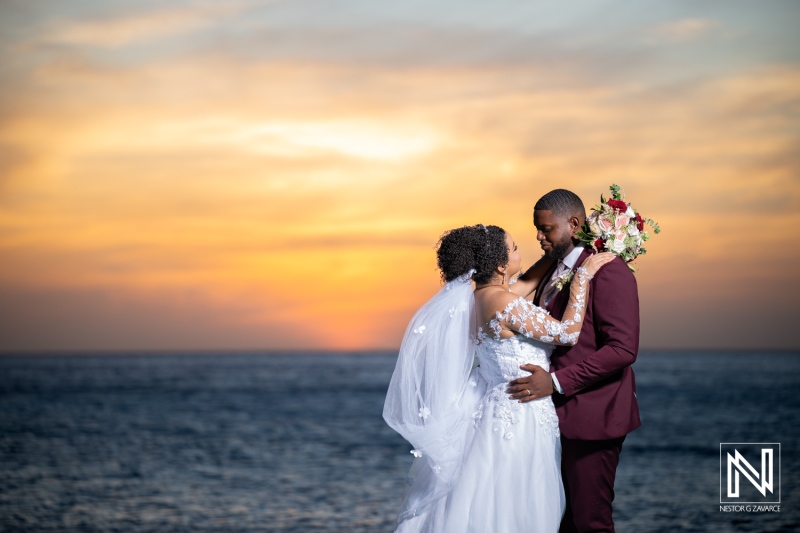 Couple shares a romantic moment at sunset during wedding celebration in Curacao
