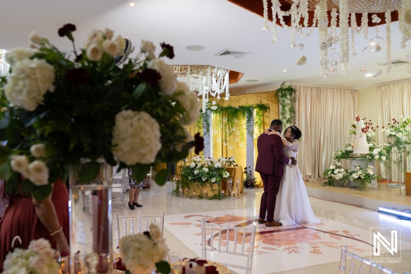 Romantic wedding reception at Marjorie's Party Palace in Curacao, featuring a beautiful first dance and floral decorations