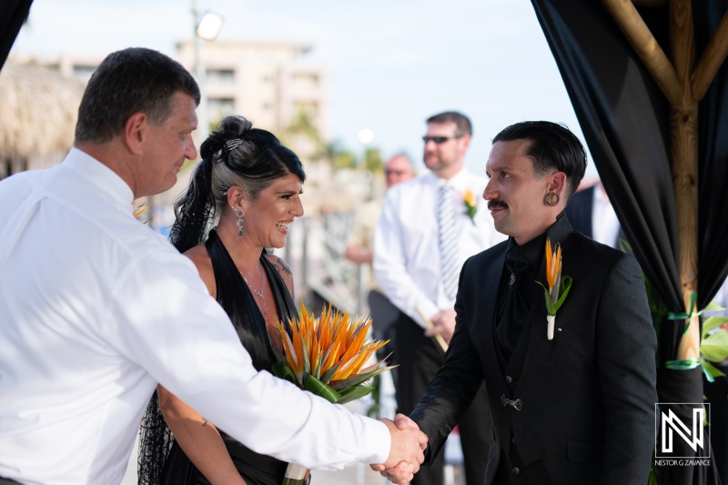 Couple exchanges vows at a Halloween-themed wedding celebration in Curacao at Sunscape Resort under a sunny sky