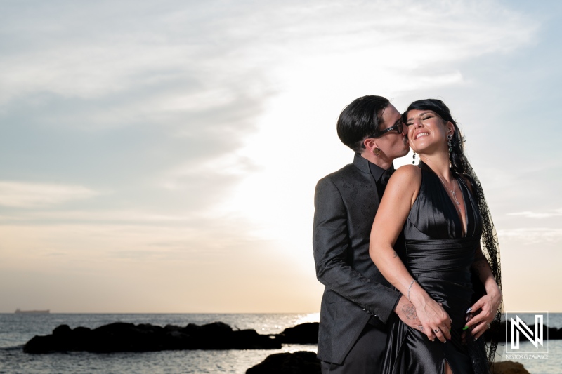 Couple celebrating their wedding at Sunscape Curacao Resort during a Halloween-themed event at sunset