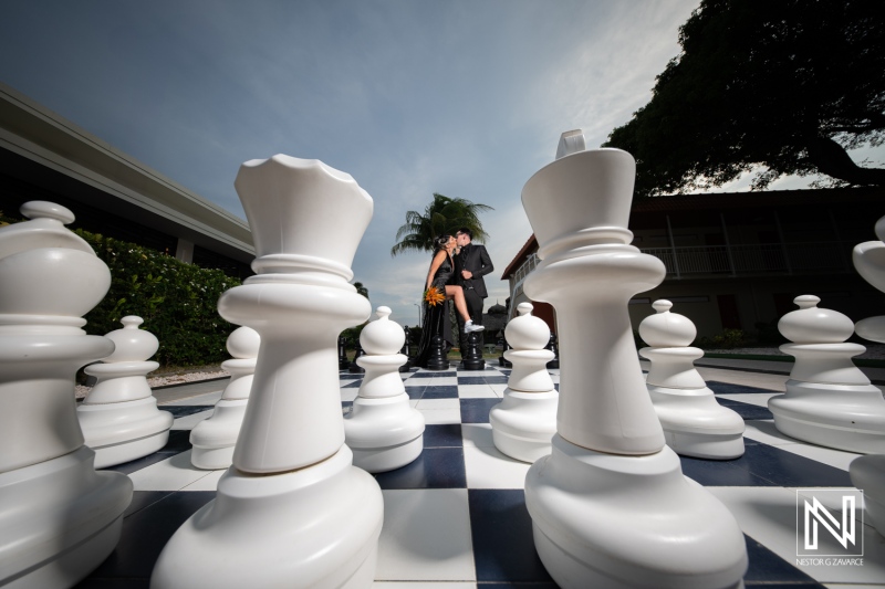 Couple celebrates Halloween wedding at Sunscape Curacao Resort with unique chess-themed backdrop