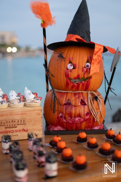 Festive Halloween celebration at Sunscape Curaçao Resort features a decorated pumpkin display and themed treats by the beach