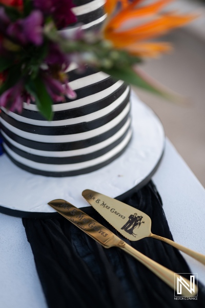 Halloween wedding cake at Sunscape Curacao Resort adorned with black and white stripes, featuring decorative flowers for a festive celebration