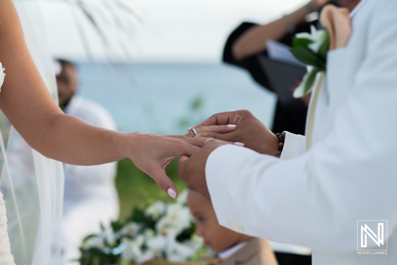 groom putting the wedding ring to the bride