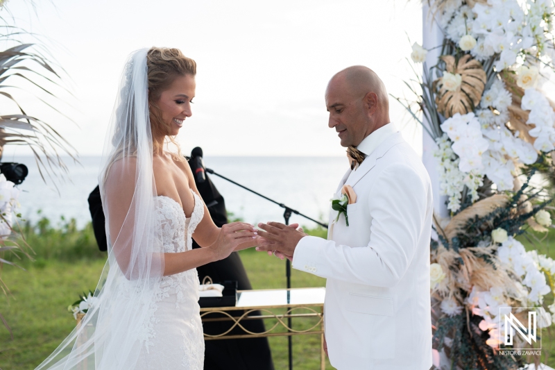bride putting the wedding ring to the groom