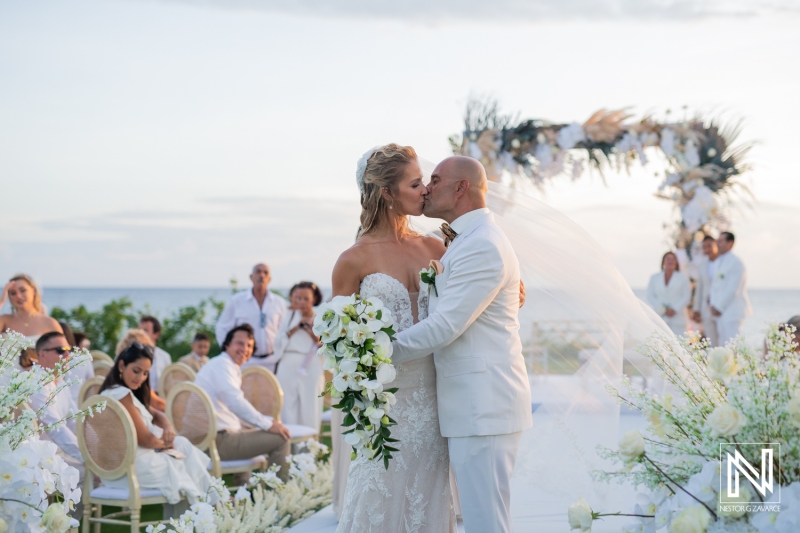 Groom and bride kissing in the golf course wedding