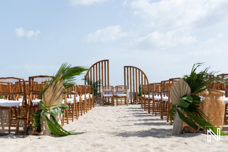 Beautiful Beachfront Wedding Setup With Chairs, Tropical Decorations, and an Ocean View Under a Clear Sky, Perfect for a Romantic Ceremony at Sunset