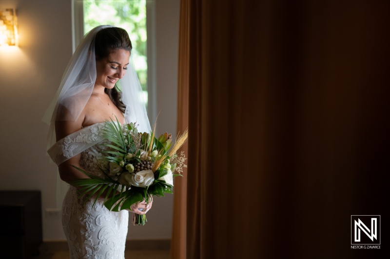 A Bride Stands Gracefully in a Softly Lit Room, Holding a Vibrant Bouquet While Preparing for Her Wedding Ceremony in a Serene Atmosphere