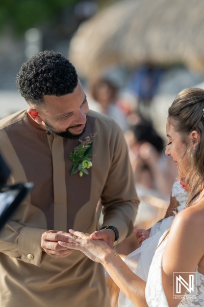 A Joyful Couple Exchanging Vows on a Sunny Beach During Their Wedding Ceremony Surrounded by Friends and Family, Capturing Their Love in a Picturesque Setting