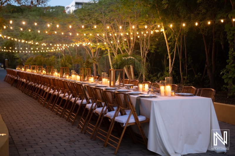 Elegant Outdoor Dining Setup With String Lights and Candles in a Serene Garden at Dusk, Perfect for Gatherings and Celebrations