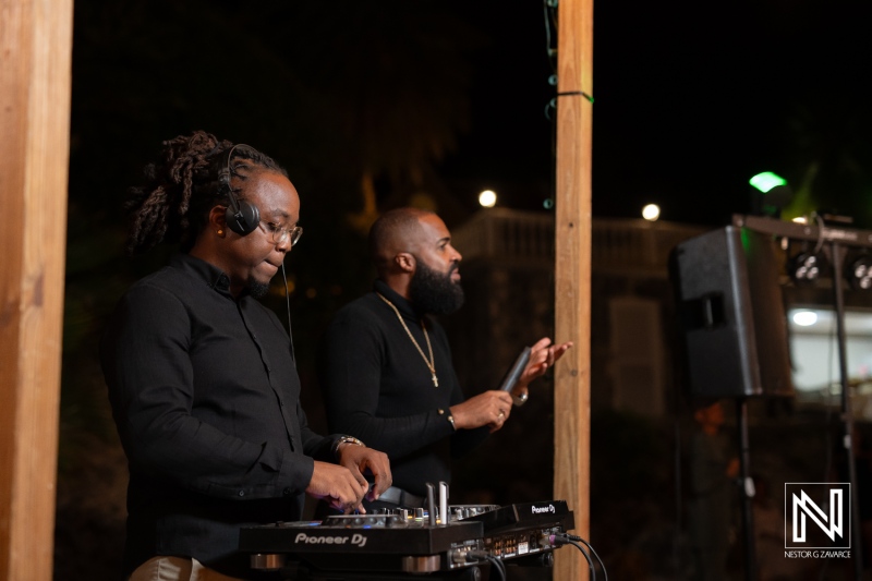 Two DJs Performing Live at an Outdoor Event Under the Night Sky, Engaging the Audience With Vibrant Music and Energy