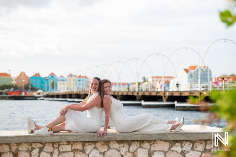 LGBT couple celebrates their love during a wedding photoshoot in the vibrant streets of Willemstad, Curacao at sunset