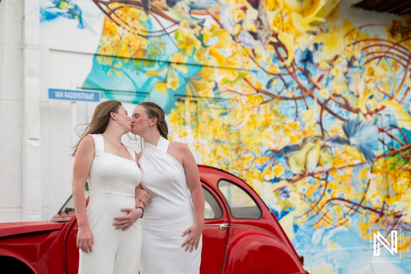 LGBT couple celebrates love during sunset wedding photoshoot in vibrant Willemstad, Curacao with colorful mural backdrop
