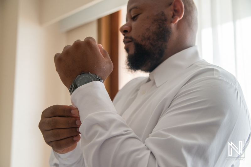 Groom getting into attire