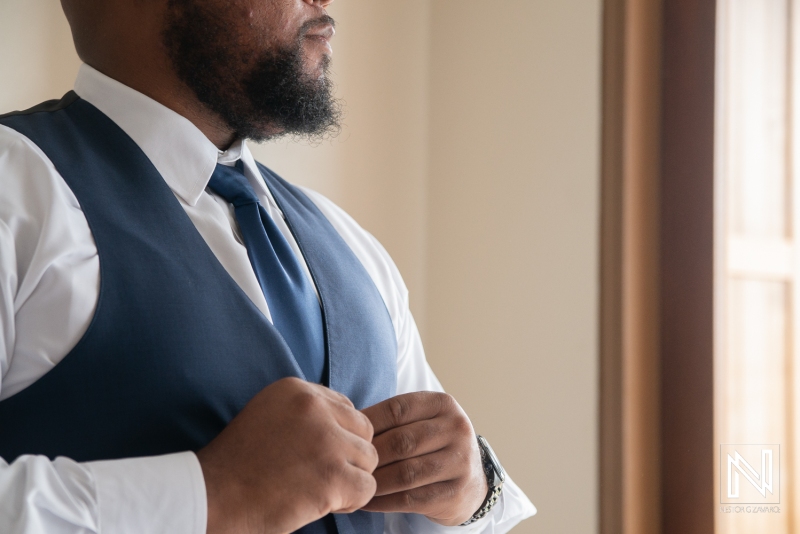 Groom getting into attire
