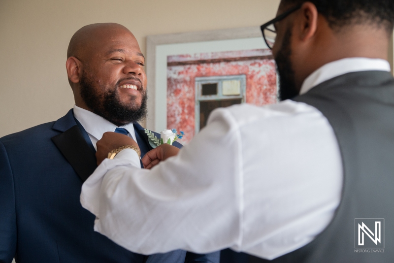 Groom getting into attire