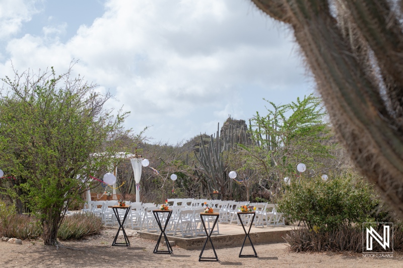 Beautiful wedding ceremony setup at Fort Beekenburg in Curacao amidst lush greenery and serene surroundings