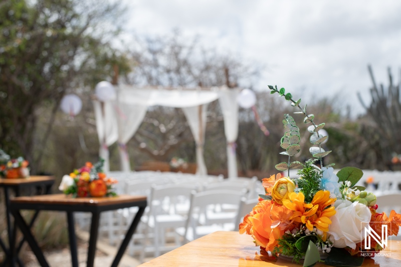 Wedding ceremony setup with floral arrangements at Fort Beekenburg in Curacao featuring natural surroundings and outdoor decor