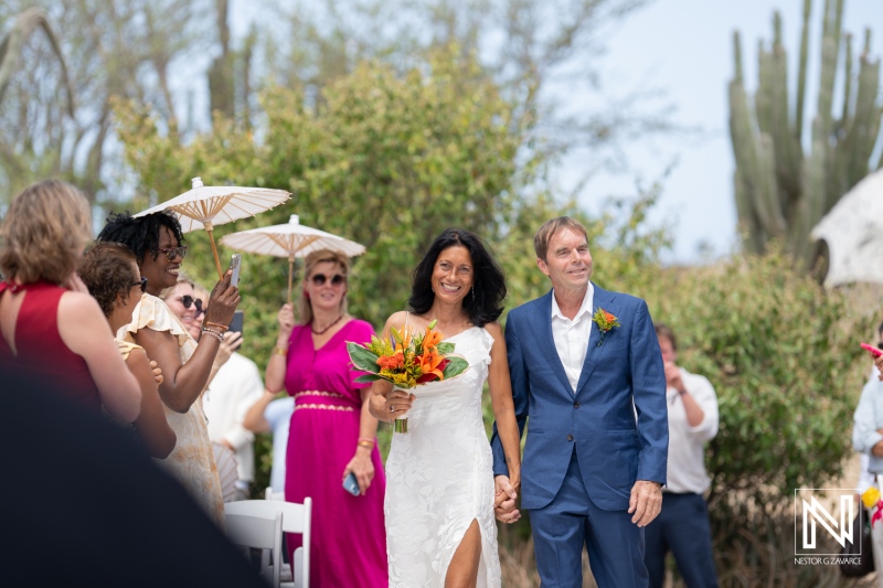 Celebration of love at Fort Beekenburg in Curacao featuring a beautiful couple walking down the aisle