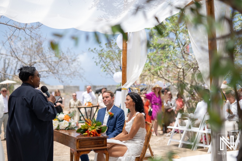Wedding ceremony at Fort Beekenburg in Curacao under a beautiful sky, celebrating love and joy with family and friends
