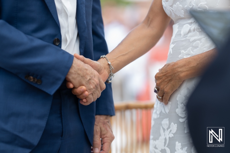 Couple exchanging vows in a heartfelt ceremony at Fort Beekenburg in Curacao under a beautiful sky during their wedding celebration