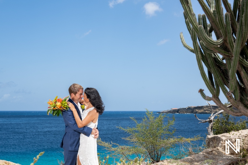 Couple exchanges vows with stunning ocean backdrop during wedding ceremony at Fort Beekenburg in Curacao