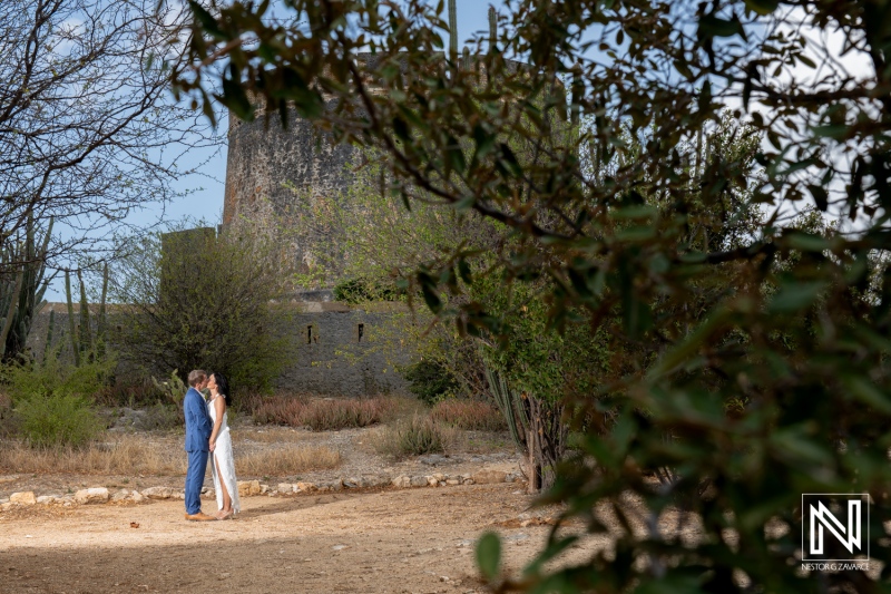 Wedding celebration at Fort Beekenburg in Curacao featuring a couple embracing in a beautiful natural setting