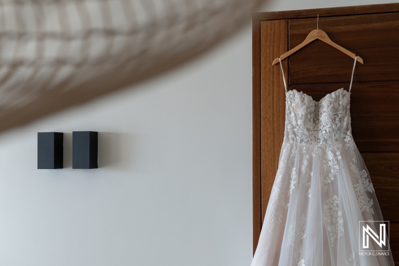 Elegant wedding dress on display in a luxurious setting in Curacao, showcasing details before the special celebration