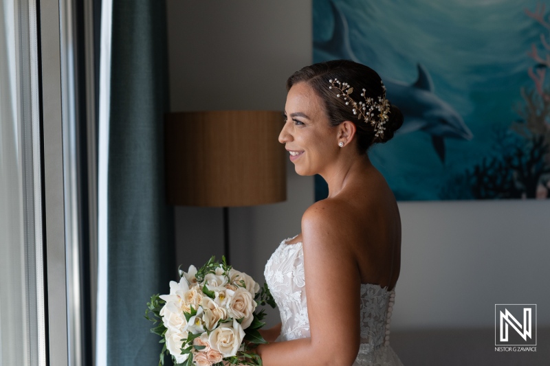 Beautiful bride poses with bouquet in Curacao, showcasing elegance and joy before wedding ceremony in tropical setting