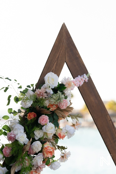 Colorful floral archway at a beach wedding in Curacao