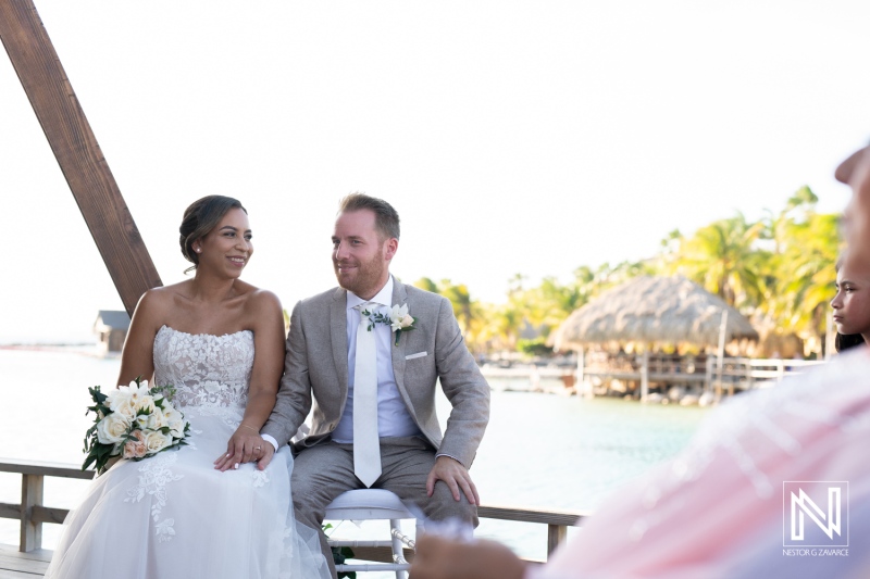 Beautiful wedding ceremony in Curacao with a couple sharing joyful moments by the water