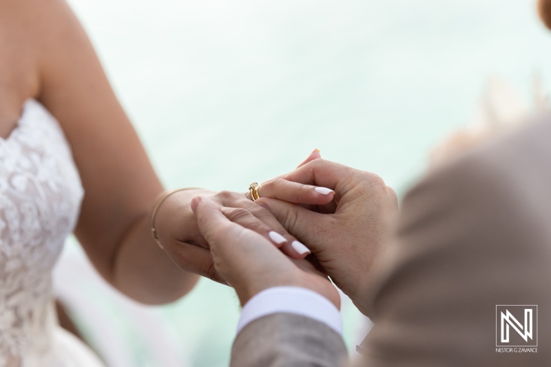 Wedding ceremony in Curacao with couples exchanging rings against a beautiful backdrop