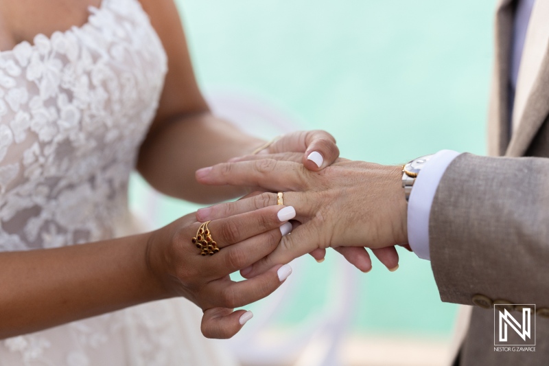 Couple exchanging wedding rings in a beautiful ceremony setting in Curacao