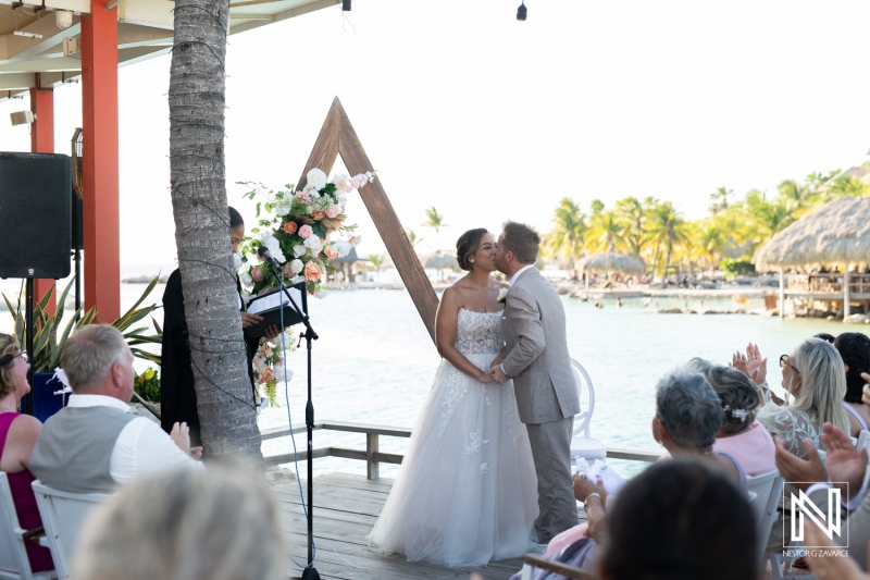 Celebration of love during a beautiful wedding ceremony in Curacao by the sea under a clear sky with guests enjoying the moment