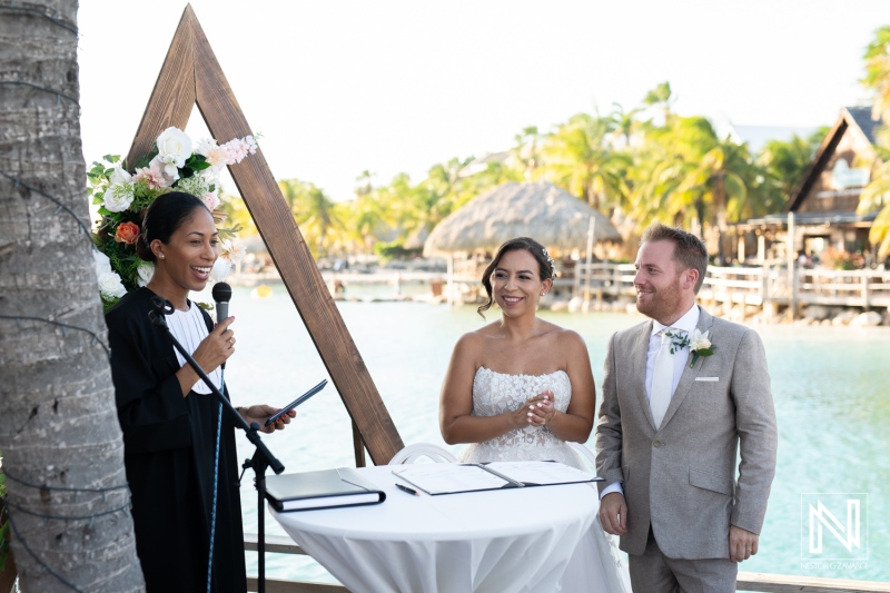 Wedding ceremony at a picturesque location in Curacao, featuring a couple and an officiant with beautiful tropical scenery