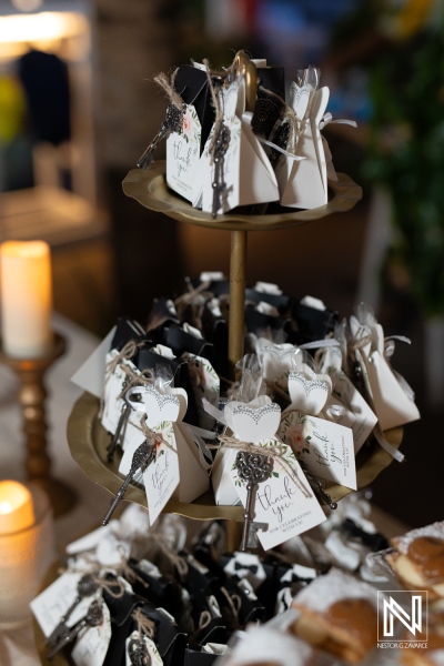 Elegant wedding favors displayed on a tiered stand at a Curacao wedding celebration with a romantic ambiance