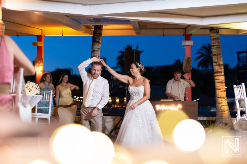 Couple celebrates their wedding with a joyful dance under the stars in Curacao