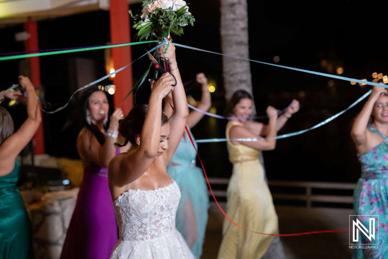 Celebration of love in Curacao with vibrant dance and joyful bride holding bouquet beneath starry night