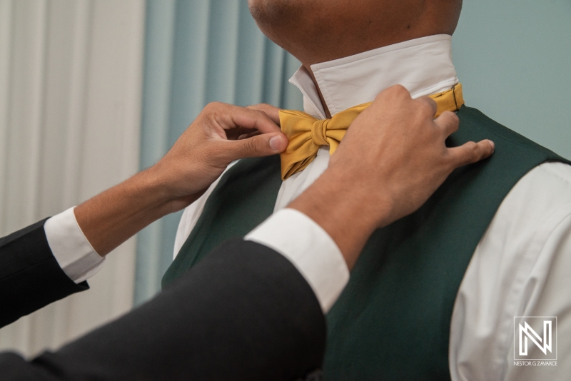 Groom getting into attire