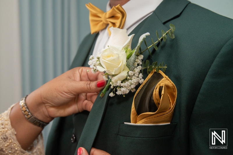 Groom getting into attire